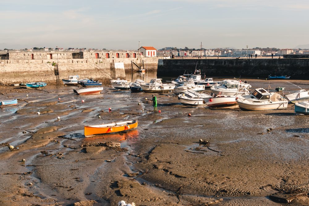 Exposed boats on moorings during a low tide 